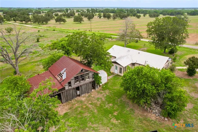 an aerial view of ocean with residential house and outdoor space