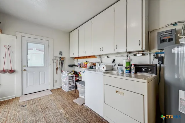 a utility room with cabinets washer and dryer