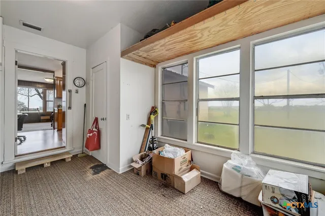 a bedroom with bed and a window