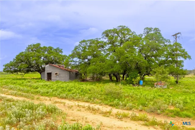 a backyard of a house with lots of green space and garden view