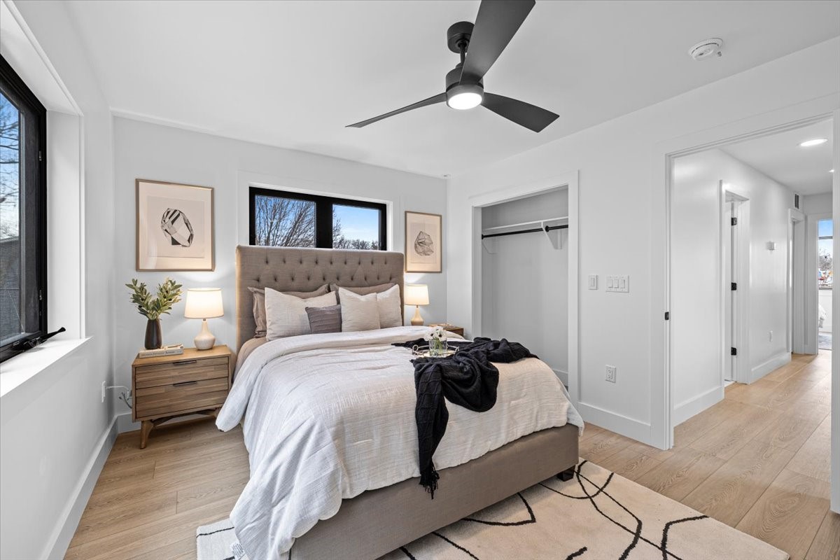 2406 West 10th Street, Unit A Austin, TX 78703 - Photo 8 of 13 a bedroom with bed and a chandelier