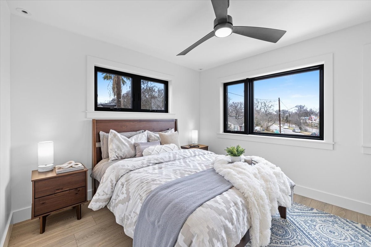 2406 West 10th Street, Unit A Austin, TX 78703 - Photo 10 of 13 a bedroom with a bed and a painting on the wall