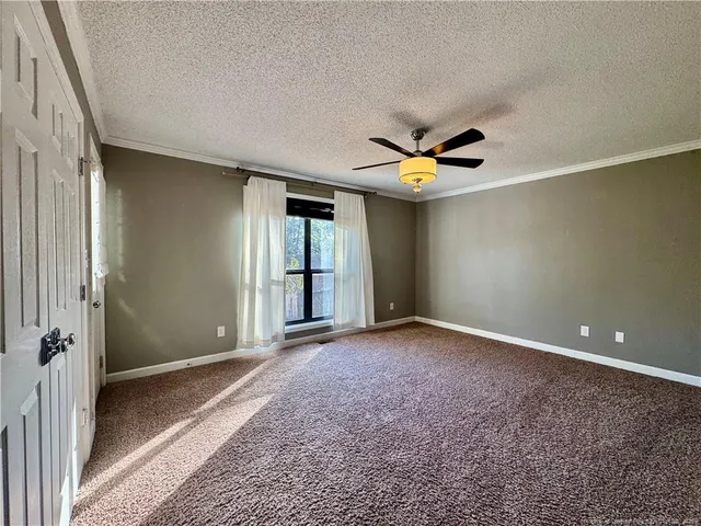 a view of a livingroom with a ceiling fan and window