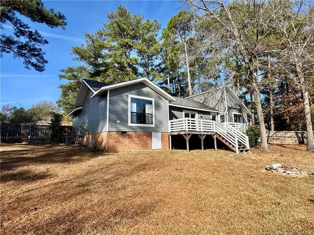 a front view of a house with a yard covered in snow