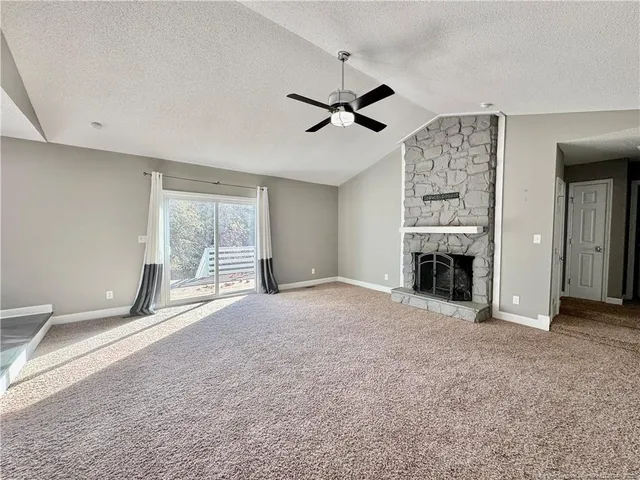 wooden floor fireplace and windows in an empty room