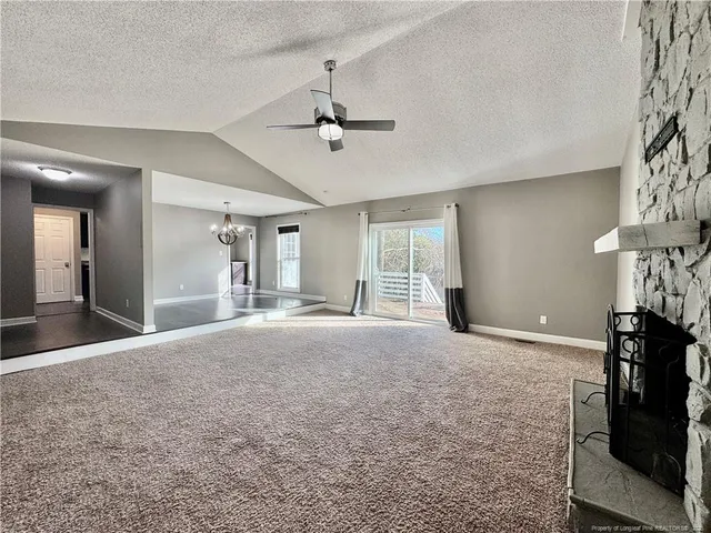 a view of empty room with ceiling fan