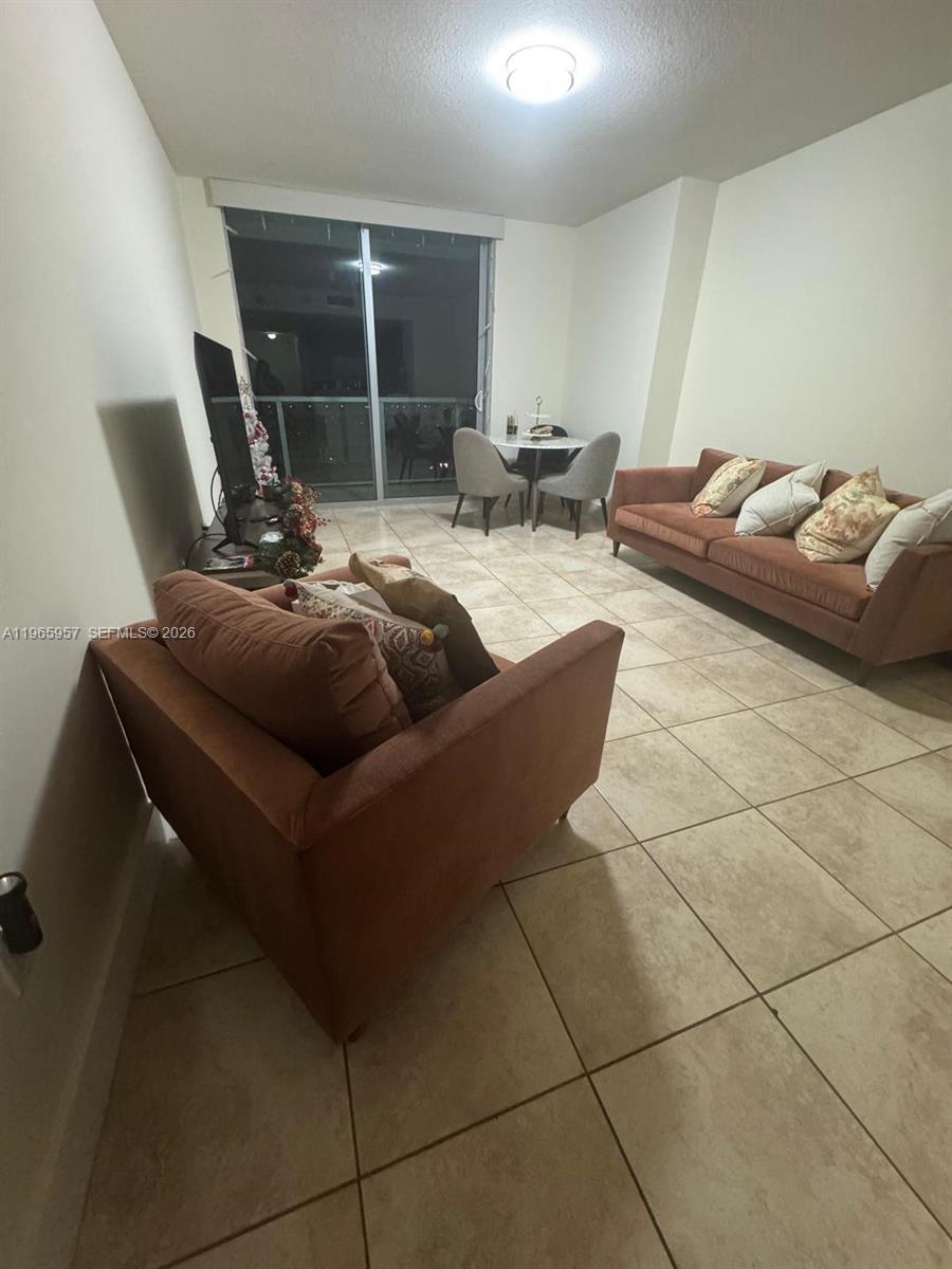 2681 North Flamingo Road, Unit 2302S Sunrise, FL 33323 - Photo 12 of 25 a living room with couches and kitchen view
