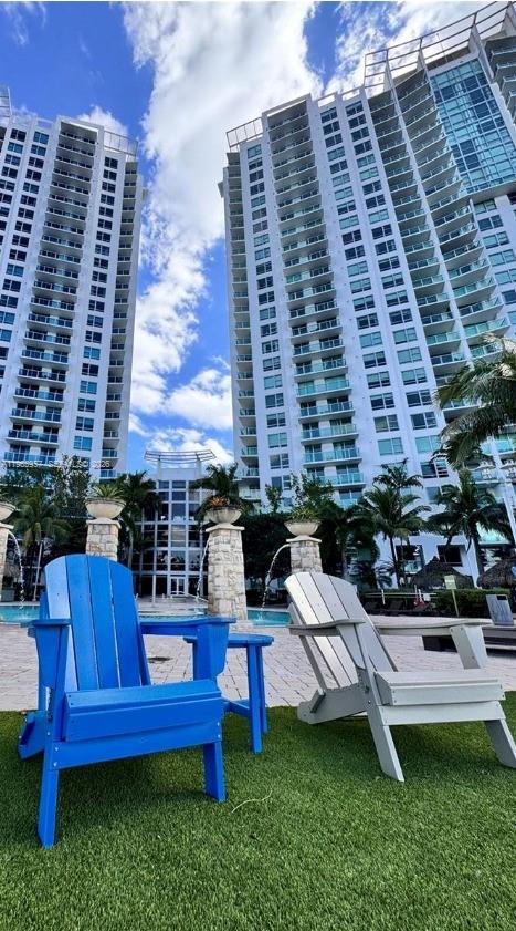 2681 North Flamingo Road, Unit 2302S Sunrise, FL 33323 - Photo 2 of 25 a view of a chairs and table in back yard of a building