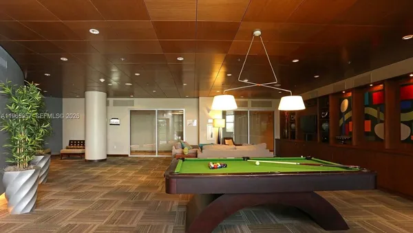 a living room with furniture and large windows