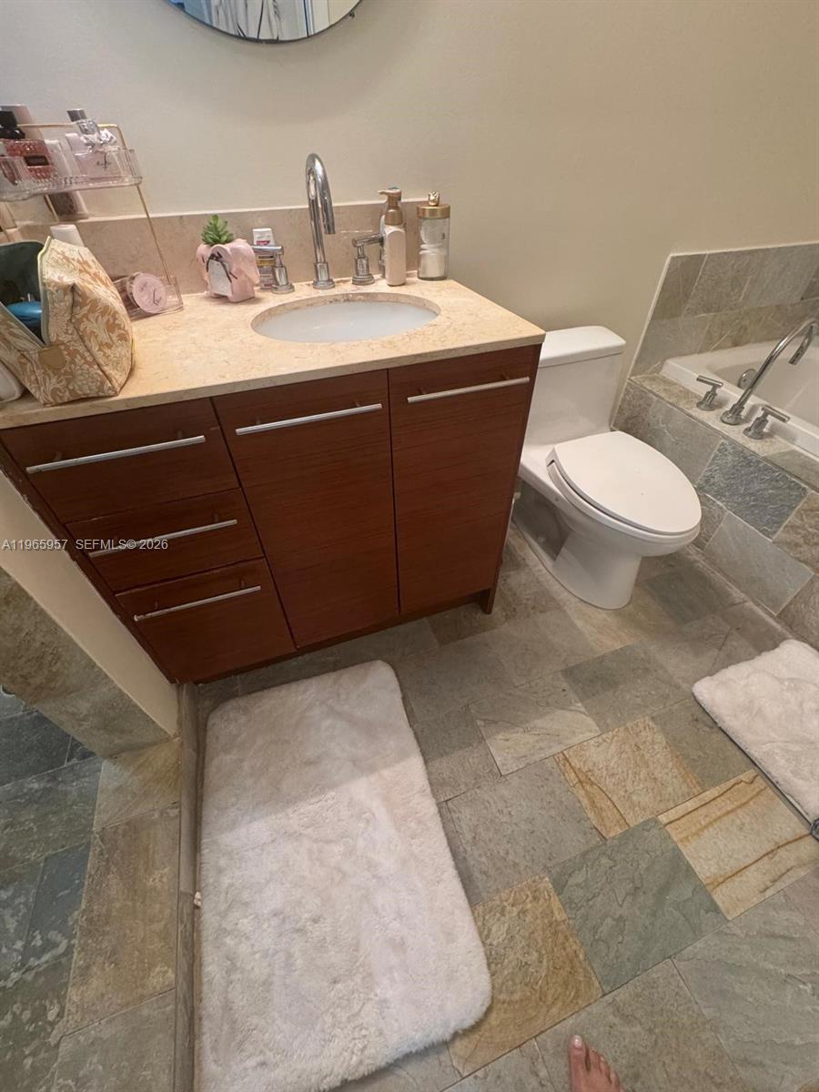 2681 North Flamingo Road, Unit 2302S Sunrise, FL 33323 - Photo 10 of 25 a bathroom with a sink and a mirror