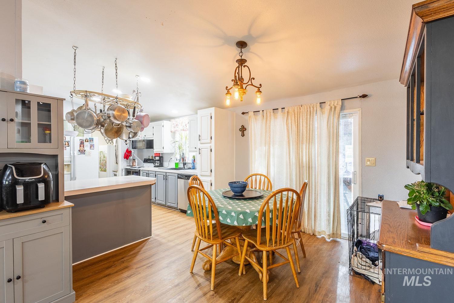 10 Reseda Ridge Circle Garden Valley, ID 83622 - Photo 6 of 28 Dining room with light wood-type flooring and a chandelier
