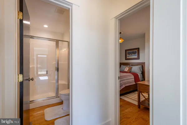 a bathroom with a glass shower door and a sink