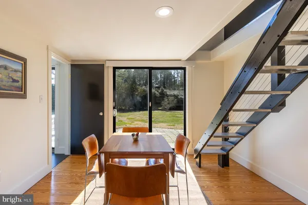 a view of a city from a dining room with furniture window and wooden floor
