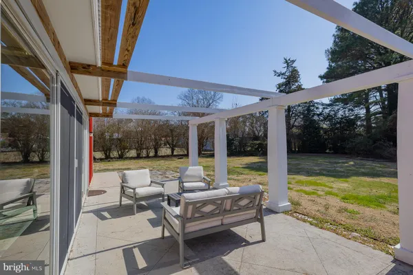 a view of swimming pool with outdoor seating and a yard