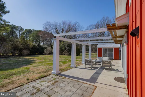 a view of a house with backyard porch and sitting area