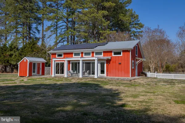 a front view of house with yard and trees