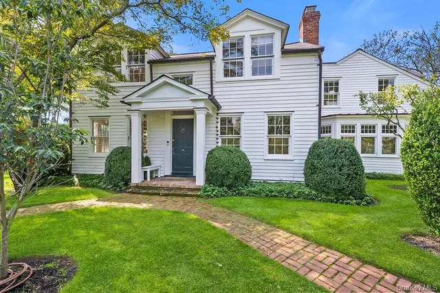 a view of a house with a yard and plants
