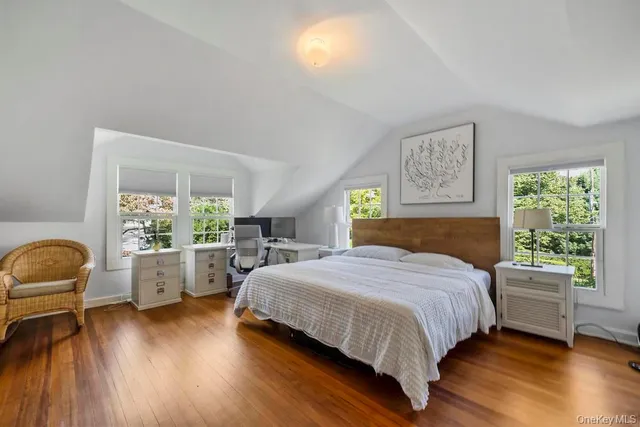 a bedroom with a bed and a wooden floor