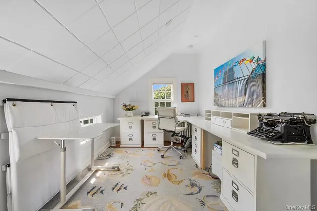 a kitchen with a sink a stove a refrigerator and white cabinets