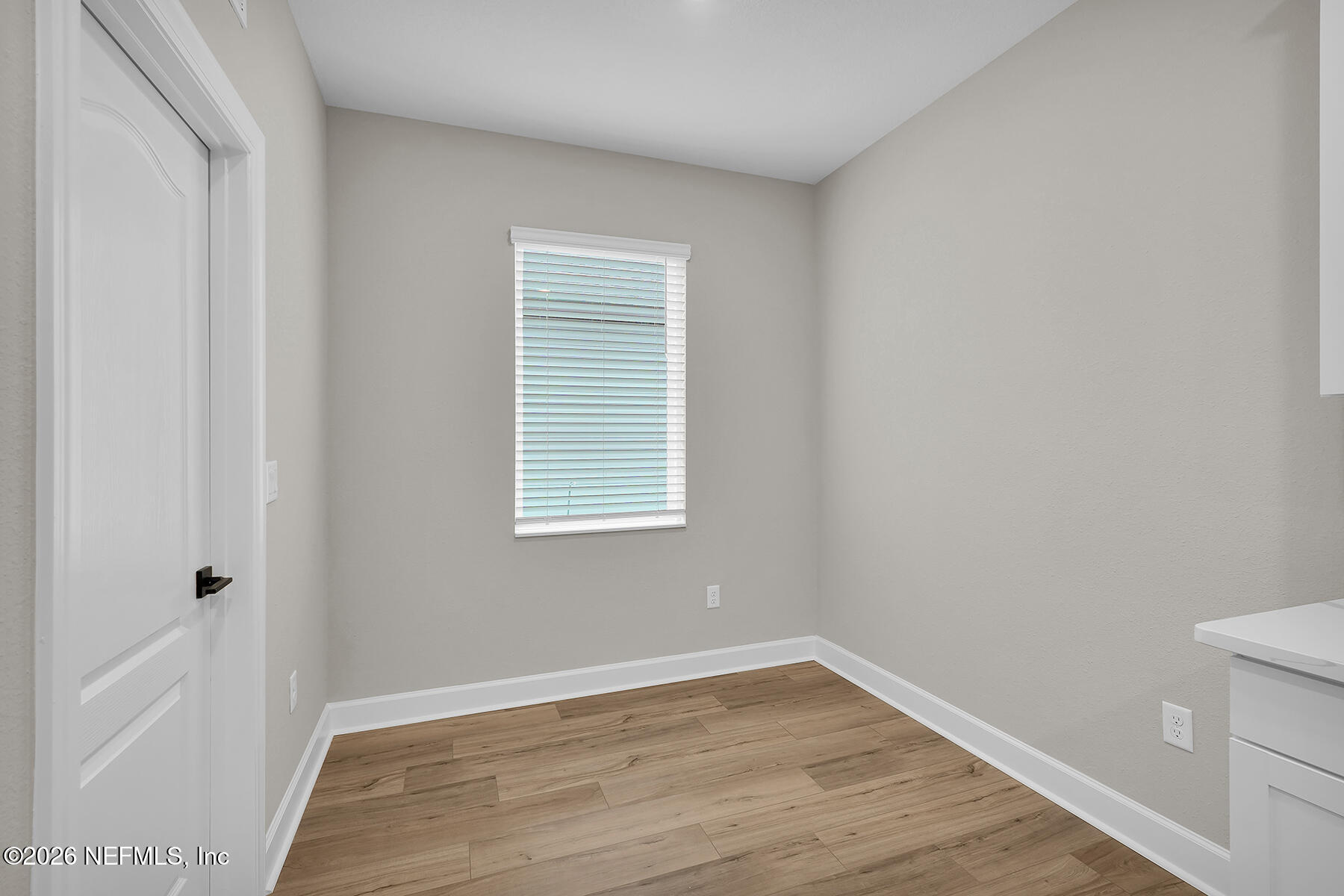 2420 Pemrose Loop Middleburg, FL 32068 - Photo 12 of 25 a view of an empty room with wooden floor and a window