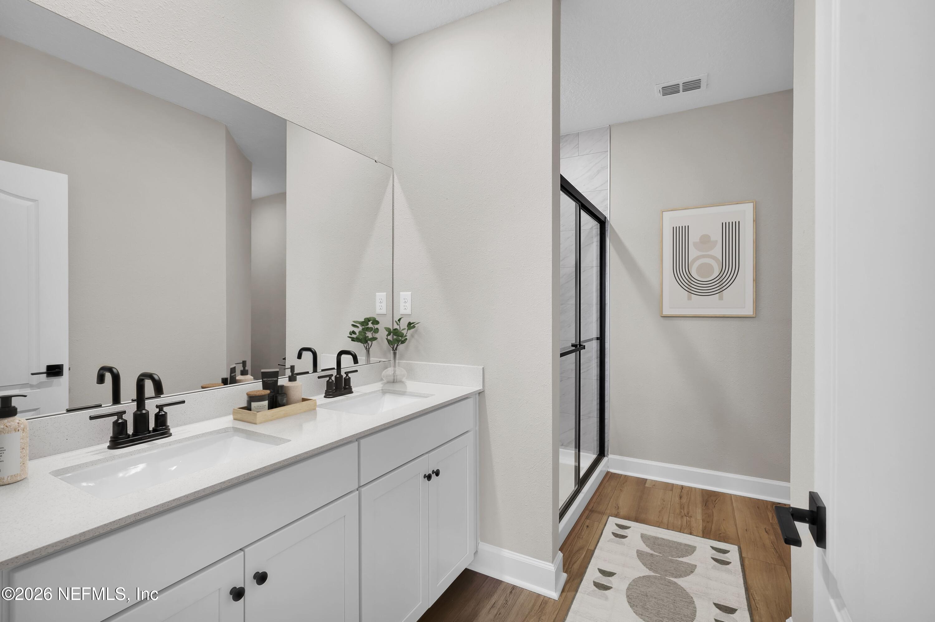 2420 Pemrose Loop Middleburg, FL 32068 - Photo 15 of 25 a bathroom with a double vanity sink and mirror