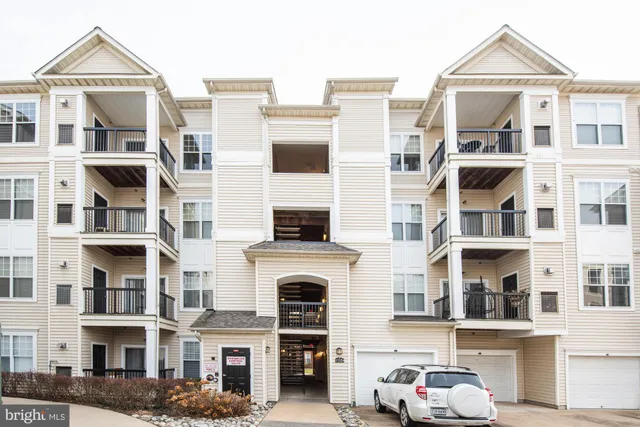 a front view of a residential apartment building with a yard