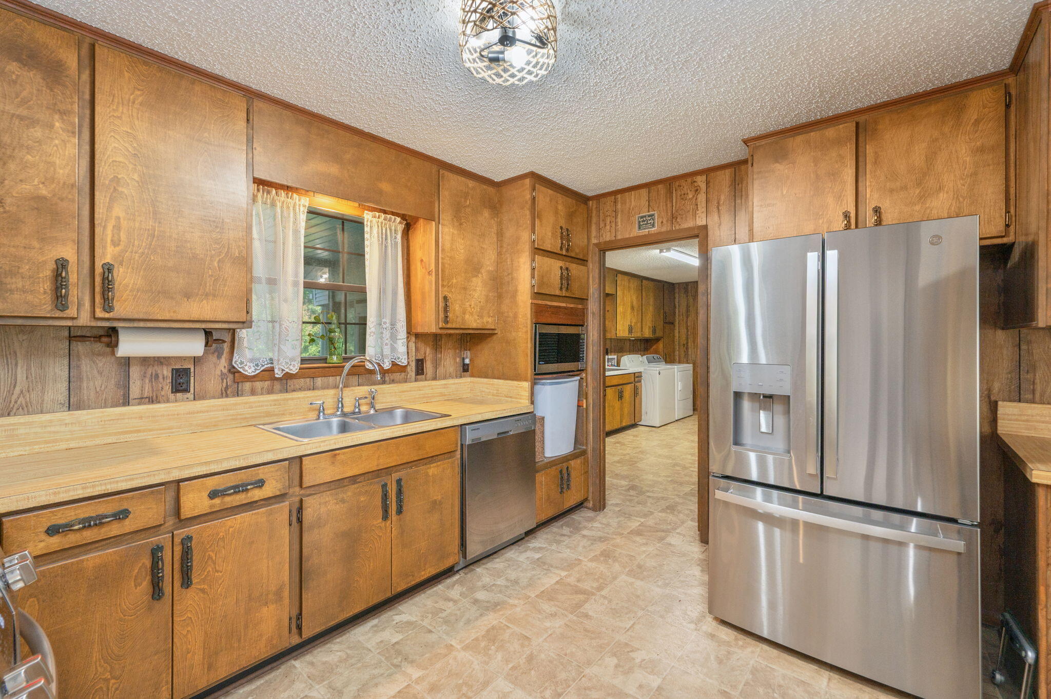 1260 East Chestnut Avenue Crestview, FL 32539 - Photo 20 of 61 a kitchen with stainless steel appliances a refrigerator sink and cabinets