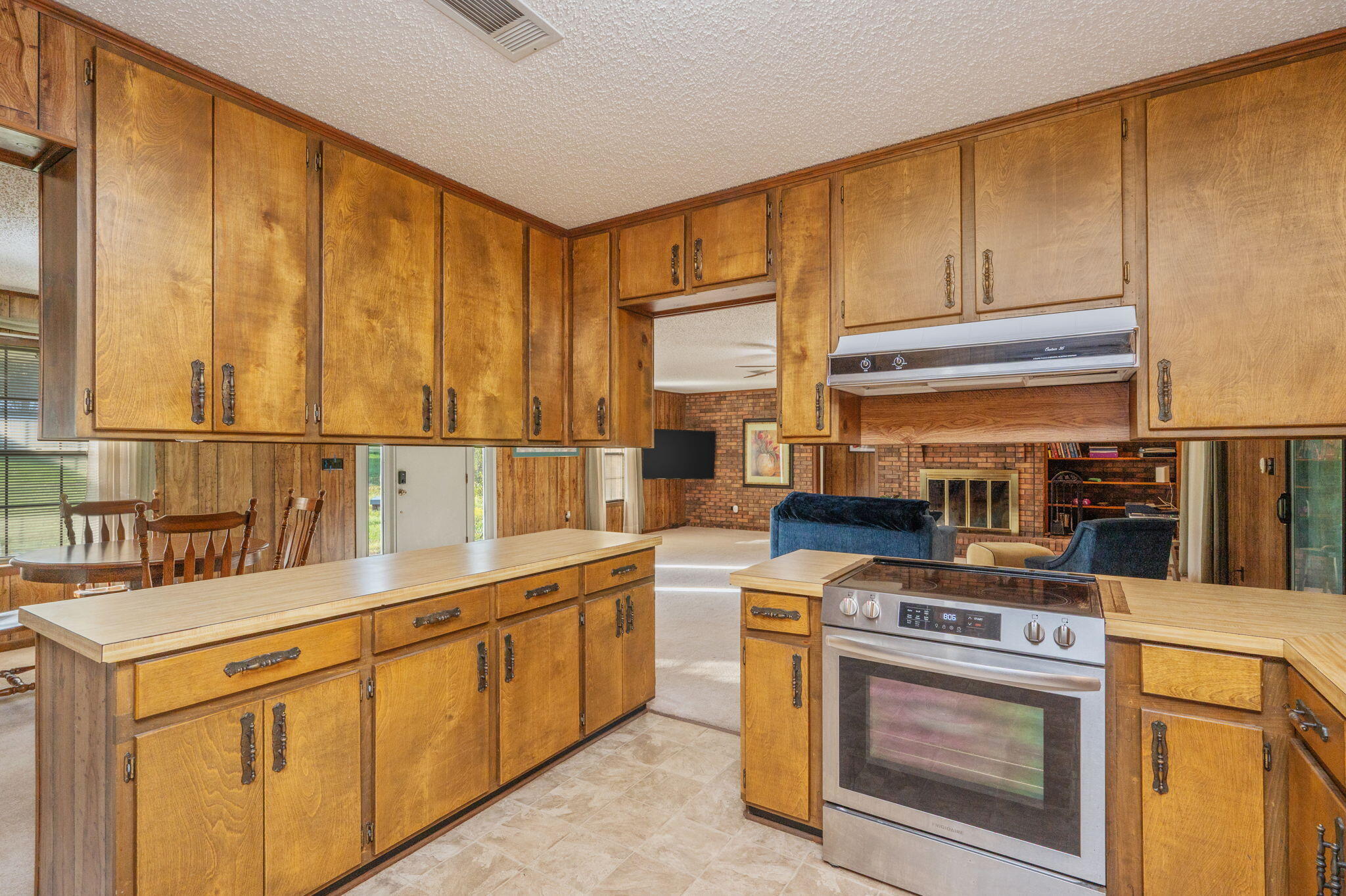 1260 East Chestnut Avenue Crestview, FL 32539 - Photo 21 of 61 a kitchen with stainless steel appliances granite countertop a stove a sink and a microwave