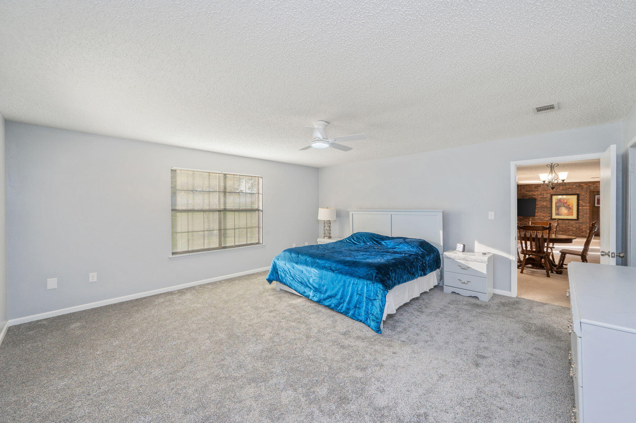 1260 East Chestnut Avenue Crestview, FL 32539 - Photo 26 of 61 a spacious bedroom with a bed and dresser