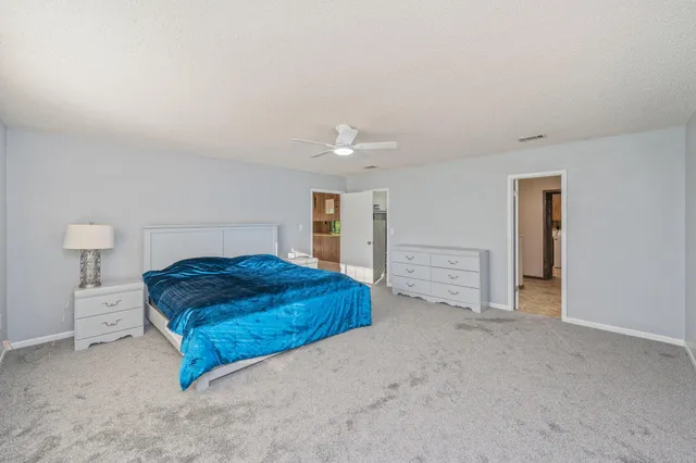 a spacious bathroom with a double vanity sink a mirror and a shower