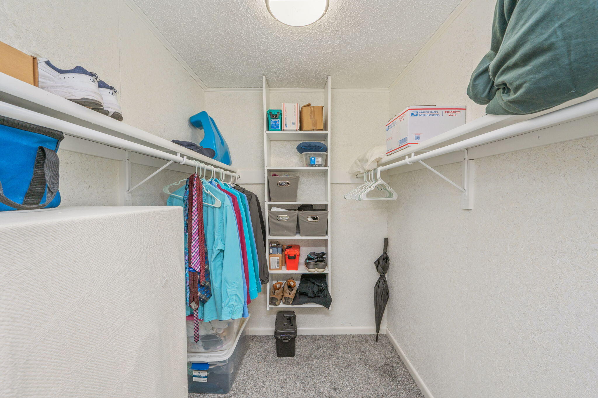 1260 East Chestnut Avenue Crestview, FL 32539 - Photo 29 of 61 a view of walk in closet with clothes and shoes