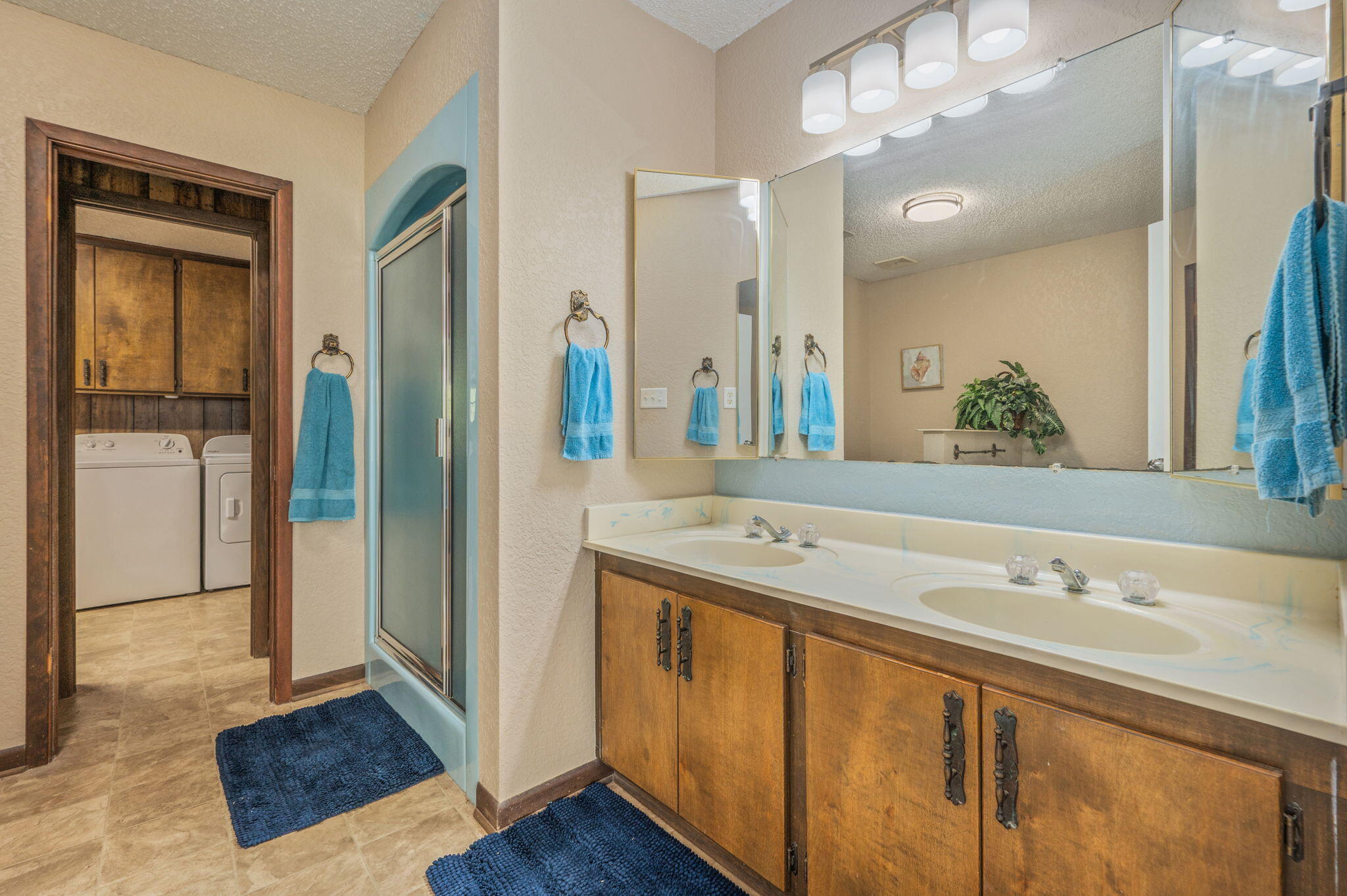 1260 East Chestnut Avenue Crestview, FL 32539 - Photo 30 of 61 a spacious bathroom with a double vanity sink a mirror and a shower