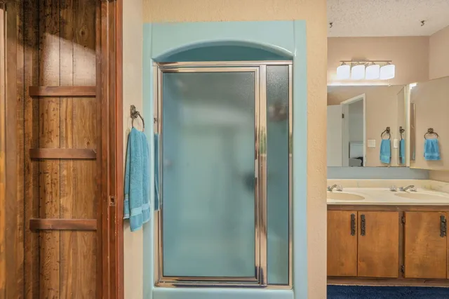a kitchen with refrigerator and cabinets