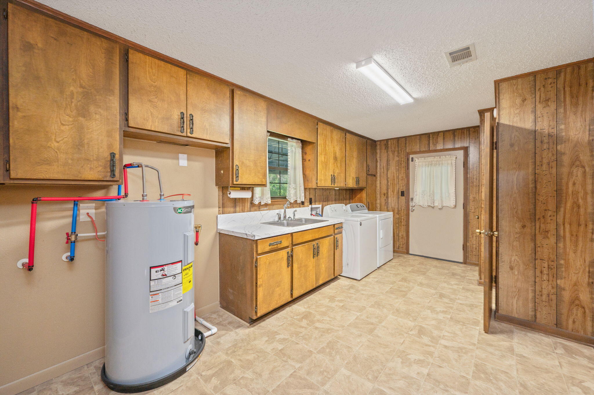 1260 East Chestnut Avenue Crestview, FL 32539 - Photo 35 of 61 a kitchen with refrigerator and cabinets