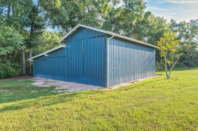 a view of backyard with wooden fence