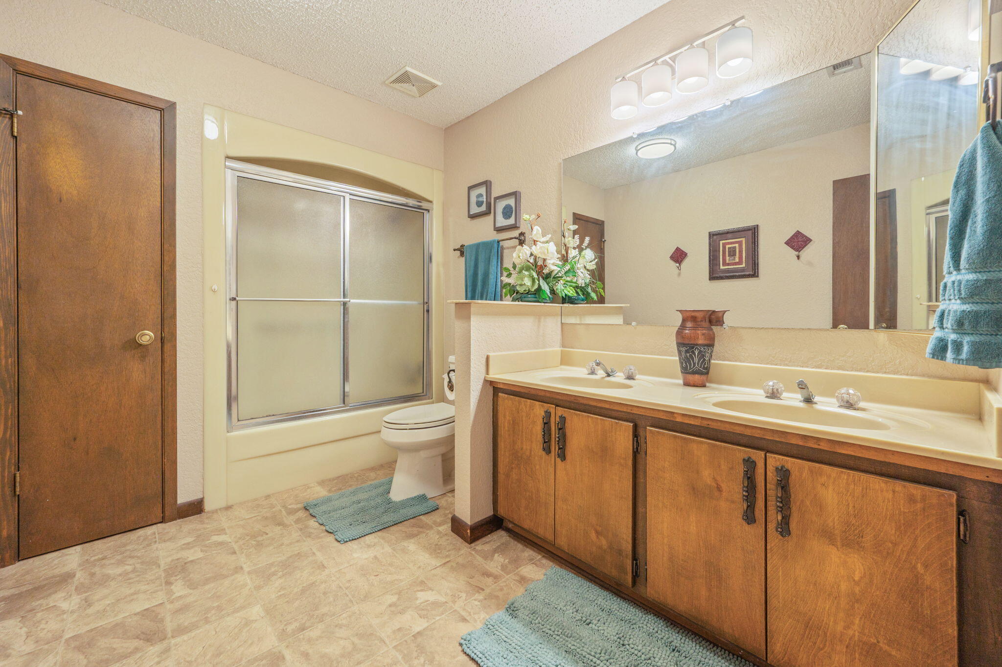 1260 East Chestnut Avenue Crestview, FL 32539 - Photo 42 of 61 a spacious bathroom with a toilet a sink and mirror