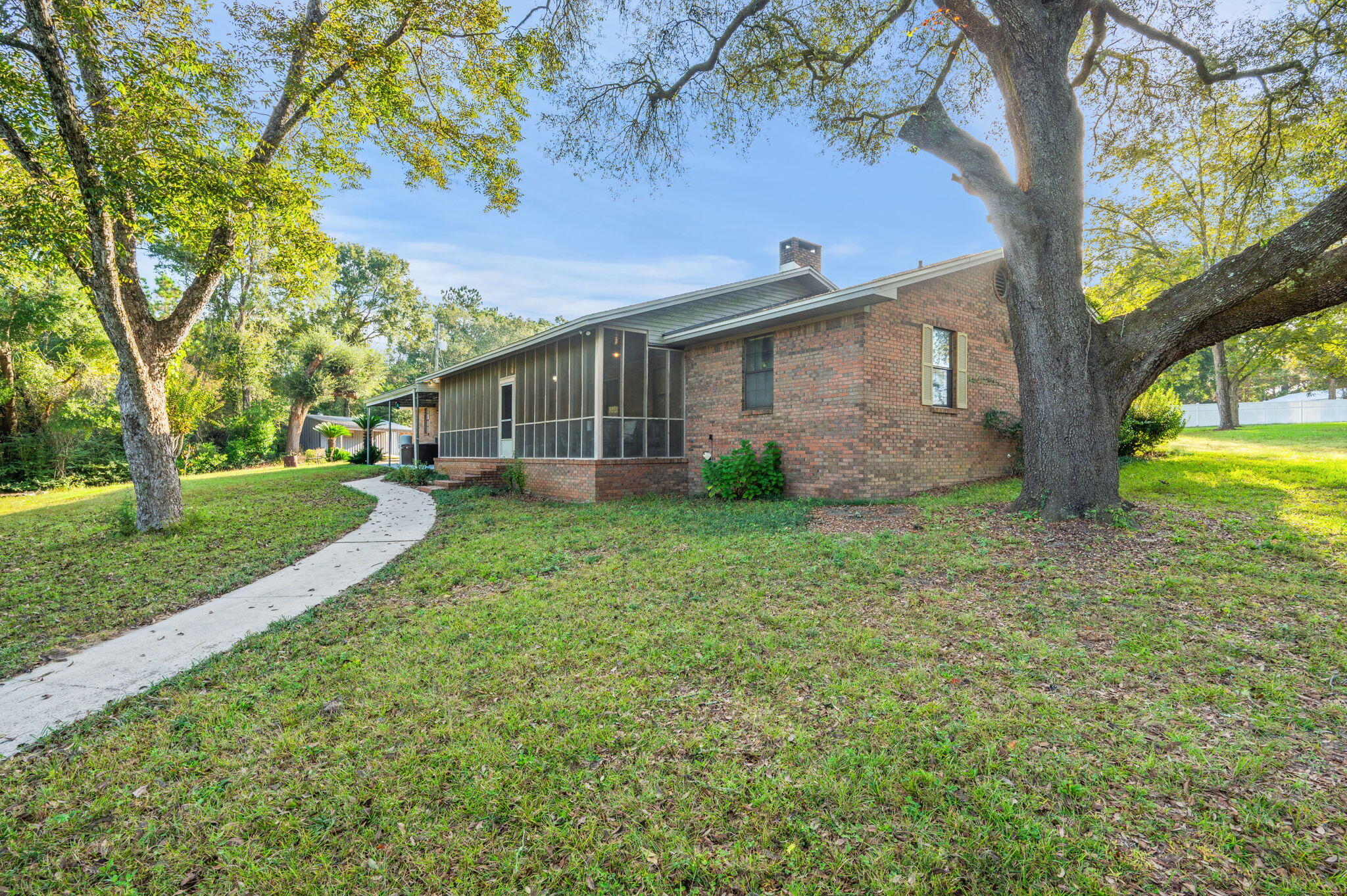 1260 East Chestnut Avenue Crestview, FL 32539 - Photo 48 of 61 a view of a house with backyard and a tree
