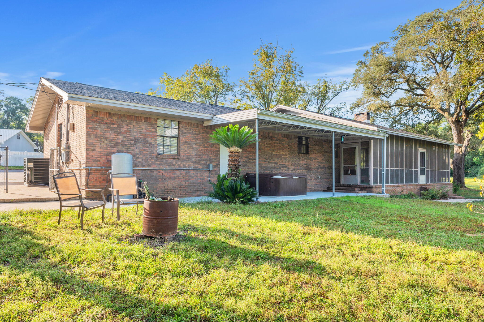 1260 East Chestnut Avenue Crestview, FL 32539 - Photo 49 of 61 a backyard of a house with table and chairs and potted plants