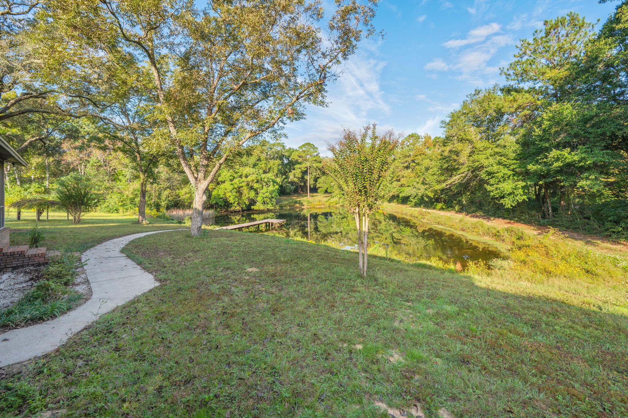 1260 East Chestnut Avenue Crestview, FL 32539 - Photo 53 of 61 a view of a field with grass and trees