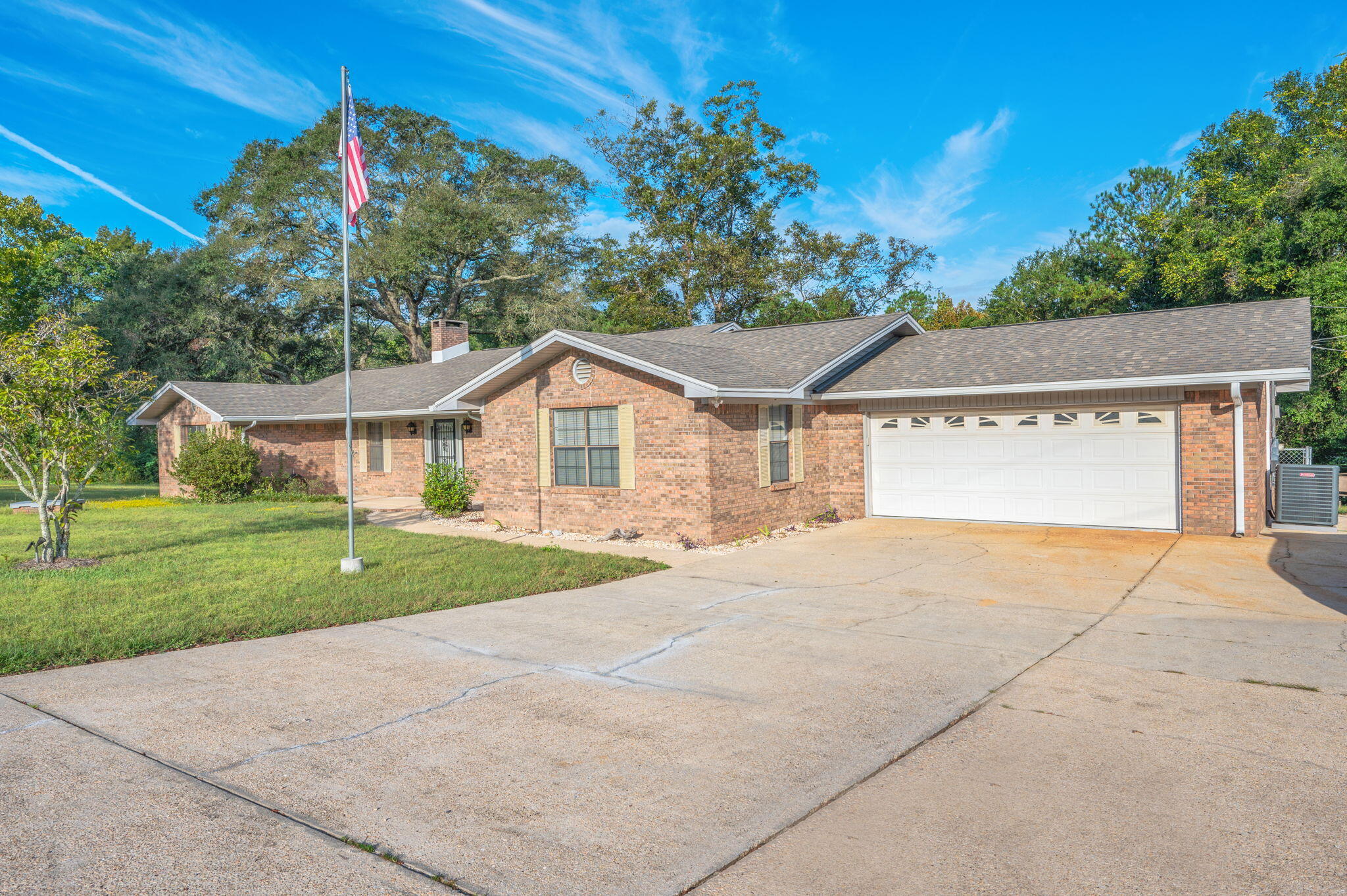 1260 East Chestnut Avenue Crestview, FL 32539 - Photo 8 of 61 a front view of a house with a yard and garage
