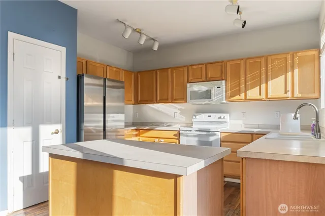 a kitchen with a sink a stove and cabinets