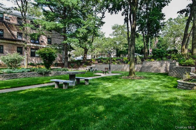 46 Terrace Circle, Unit 1B Great Neck, NY 11021 - Photo 14 of 16 a view of a park with bench and trees