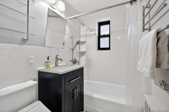 46 Terrace Circle, Unit 1B Great Neck, NY 11021 - Photo 8 of 16 a bathroom with a granite countertop sink a toilet and shower