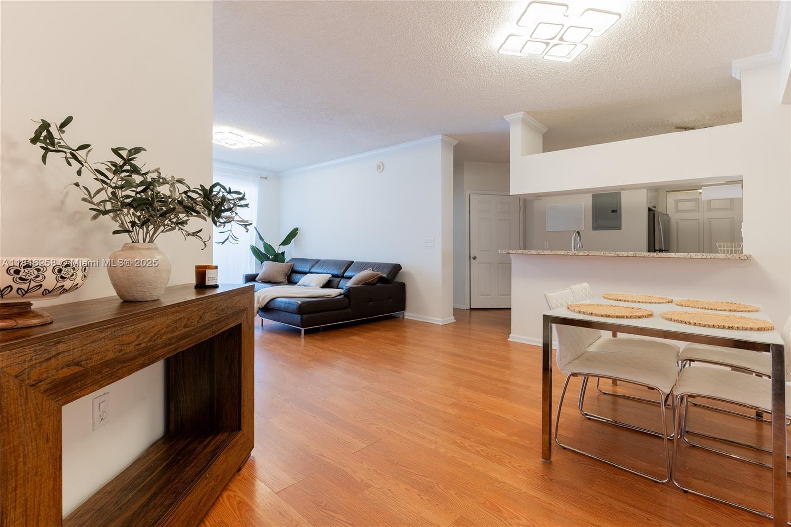 17100 North Bay Road, Unit PH1912 Sunny Isles Beach, FL 33160 - Photo 1 of 39 a living room with furniture wooden floor and a kitchen view