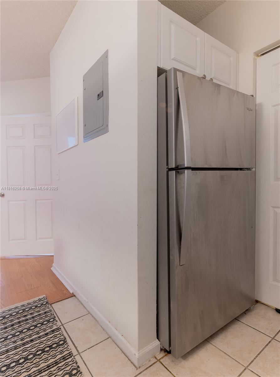 17100 North Bay Road, Unit PH1912 Sunny Isles Beach, FL 33160 - Photo 12 of 39 a view of a refrigerator in kitchen and white cabinets