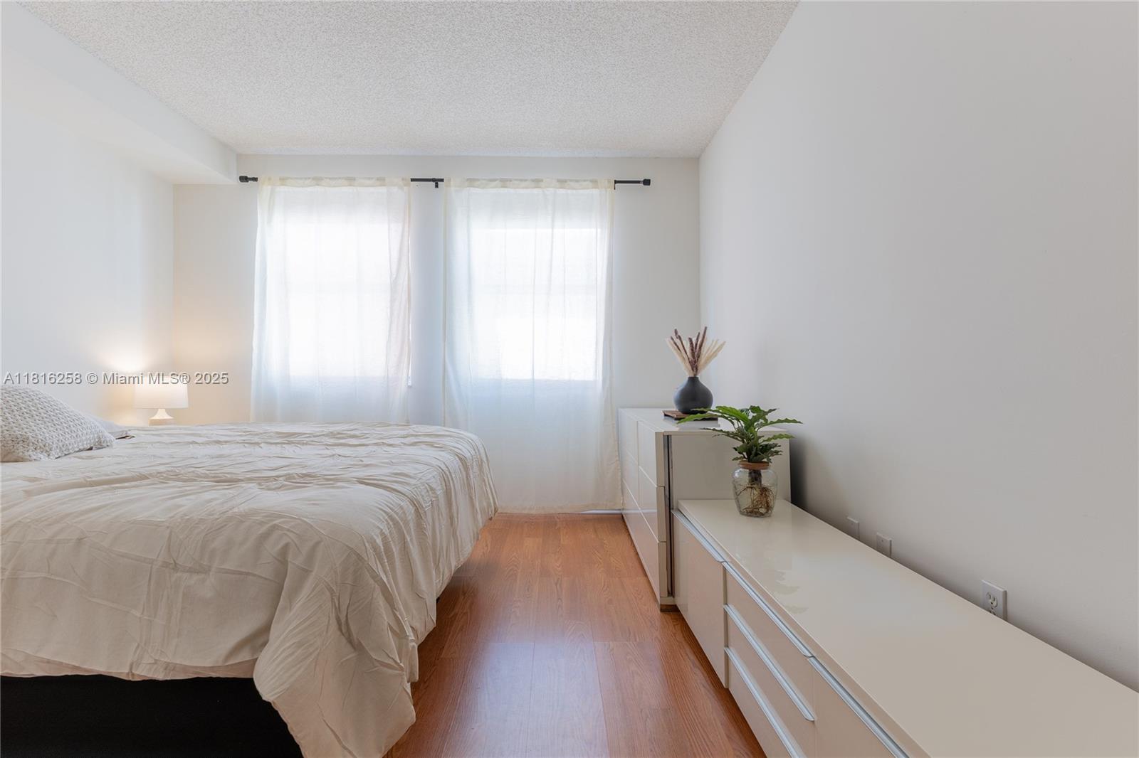 17100 North Bay Road, Unit PH1912 Sunny Isles Beach, FL 33160 - Photo 14 of 39 a bedroom with a bed and a window