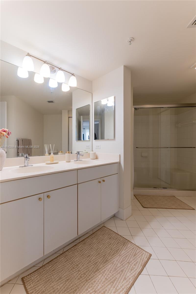 17100 North Bay Road, Unit PH1912 Sunny Isles Beach, FL 33160 - Photo 20 of 39 a spacious bathroom with a mirror sink and shower