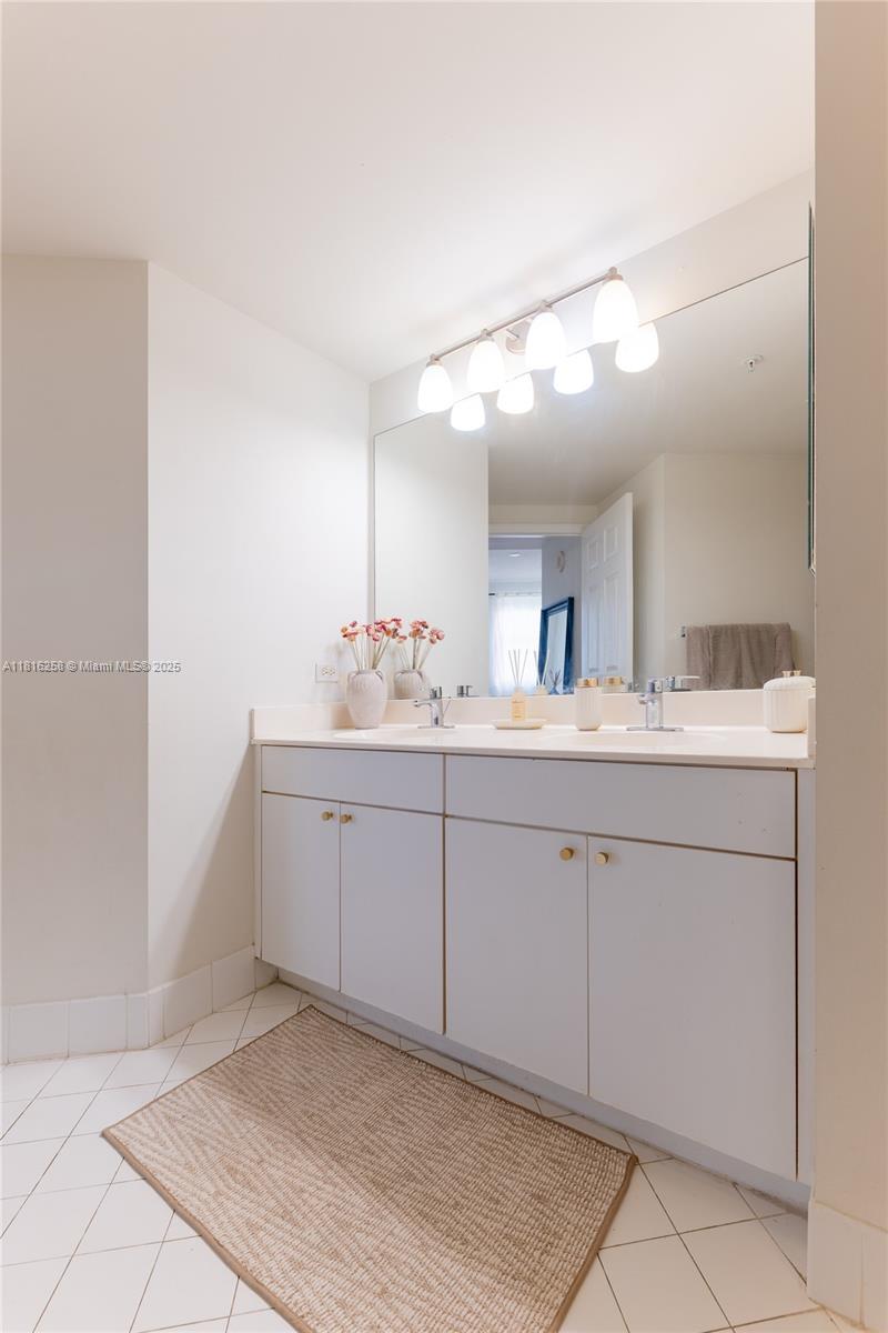 17100 North Bay Road, Unit PH1912 Sunny Isles Beach, FL 33160 - Photo 22 of 39 a spacious bathroom with a granite countertop sink and a mirror