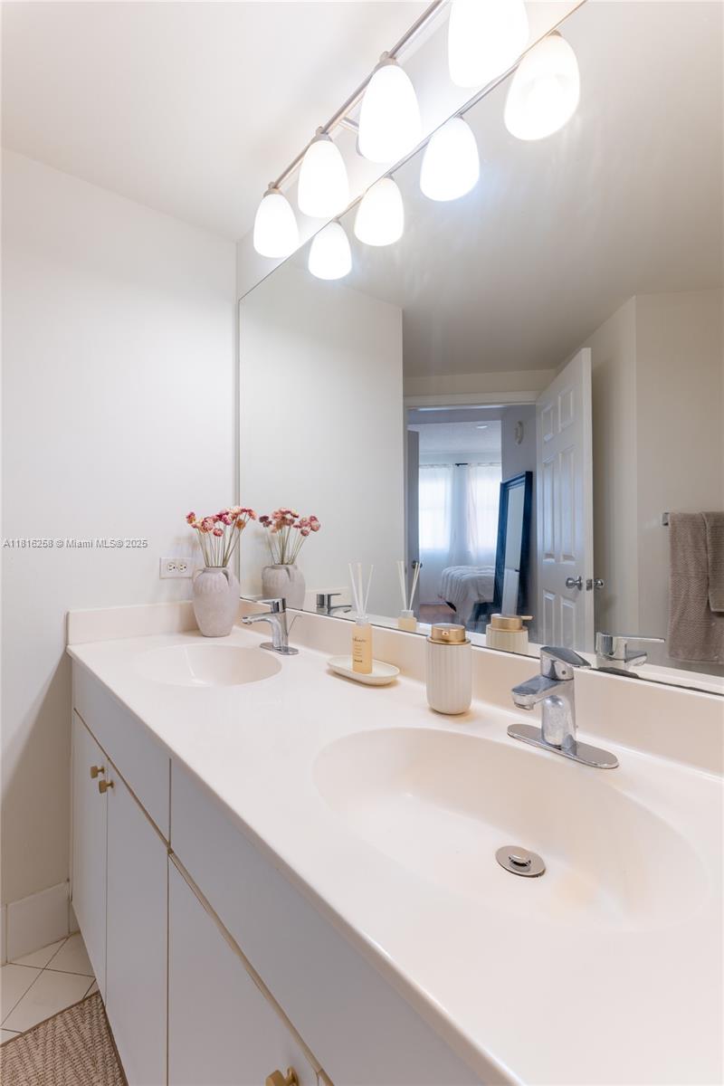 17100 North Bay Road, Unit PH1912 Sunny Isles Beach, FL 33160 - Photo 23 of 39 a bathroom with a sink vanity and a mirror