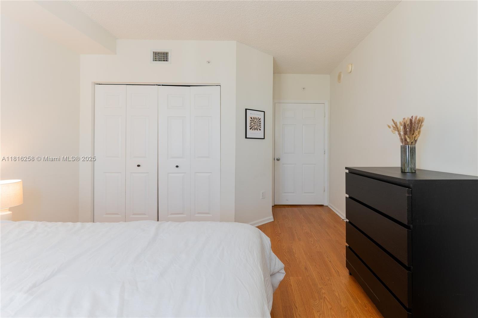 17100 North Bay Road, Unit PH1912 Sunny Isles Beach, FL 33160 - Photo 25 of 39 a bedroom with a bed and a lamp